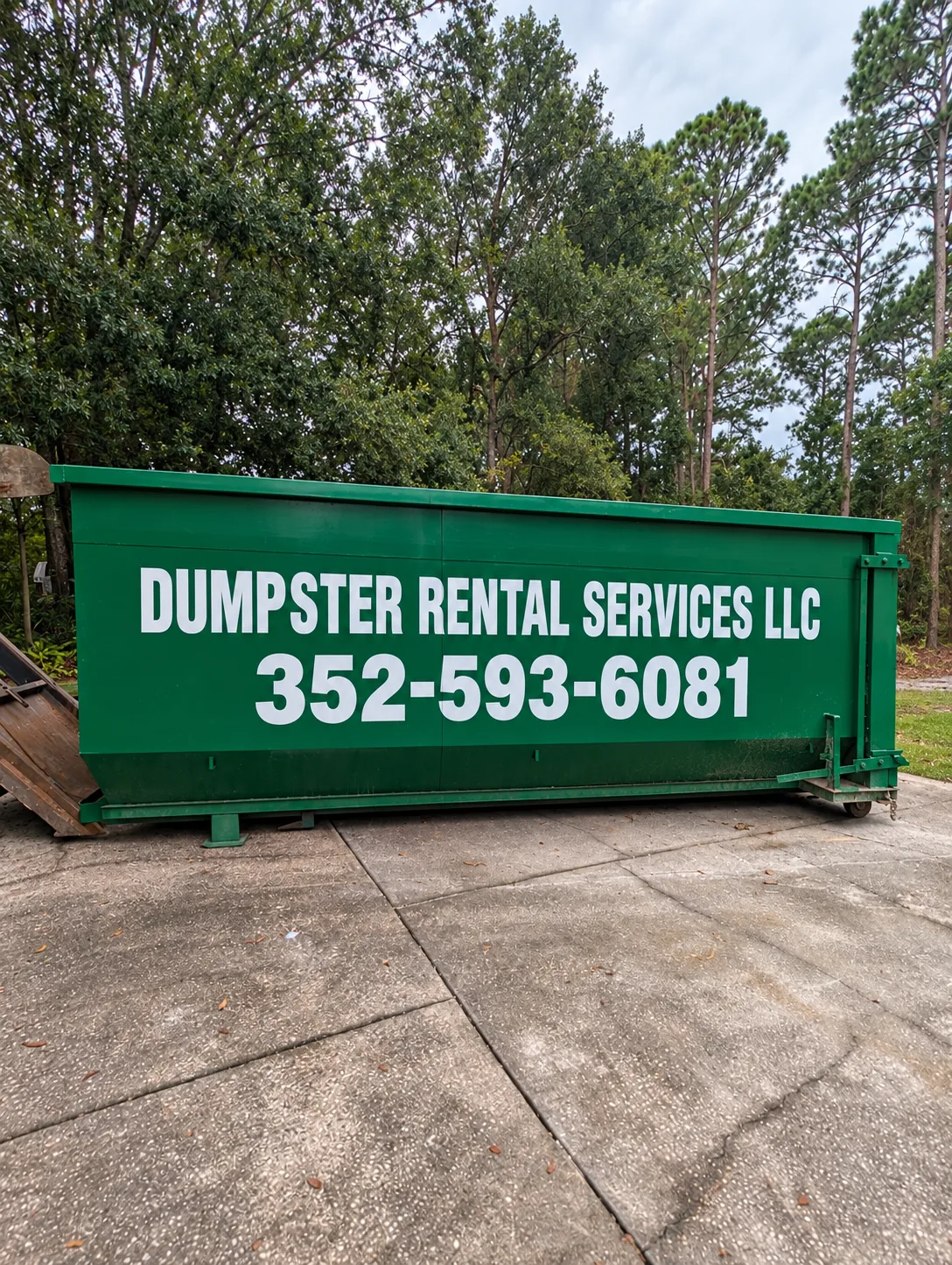 Green 30 yard Dumpster Rental Services roll-off dumpster with business phone number